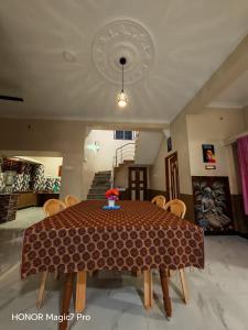 a dining room with a table and some chairs at ARMANI Villa Nagapattinam in Sikkil