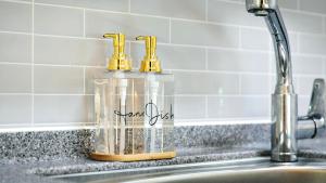 a bottle of soap sitting on a kitchen sink at Busan Ieumjae Seomyeon Station in Busan +50 photos