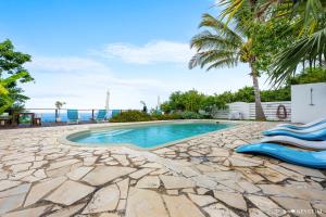 a swimming pool with a view of the ocean at Kaz Ocean in Saint-Leu