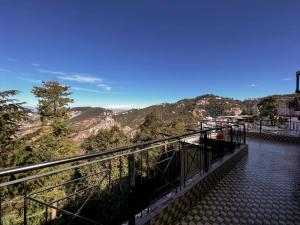 a balcony with a view of a mountain at Nirvana Rooms near Mall Road in Shimla