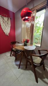 a dining room with a table and a red lamp at Casa Mercedes in Valladolid