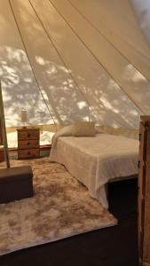 a bedroom with a bed in a tent at Finca los ciervos in Apan