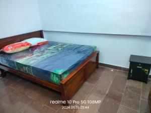 a bed with two pillows on it in a room at APM Palace in Palaiya Ayakkudi