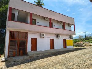 a building with red doors on the side of it at APM Palace in Palaiya Ayakkudi