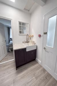 a bathroom with a sink and a mirror at Corbridge Apartment in Corbridge +90 photos