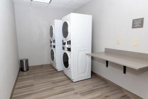 two washing machines in a laundry room with a counter at Hampton Inn Rawlins in Rawlins