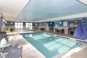 a pool in a hotel with chairs and a table at Hampton Inn Rawlins in Rawlins