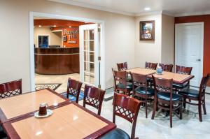 a restaurant with tables and chairs and a bar at Rodeway Inn San Diego Near SDSU in San Diego