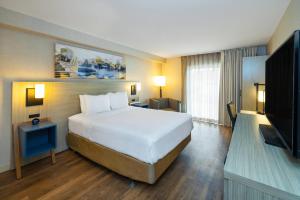 a hotel room with a bed and a television at Comfort Inn in Edmundston
