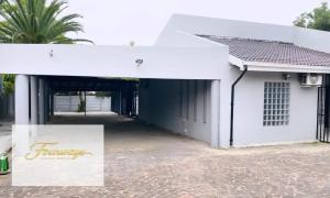 a white building with a sign in front of it at Fourways Executive Residence in Four Ways