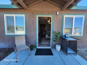 a house with a porch with a table and a desk at Sunrise Springs in Pahrump +72 photos