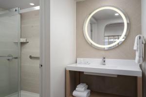 a bathroom with a sink and a mirror at The Harrison Hotel Downtown Hollywood FL, an Ascend Collection Hotel in Hollywood