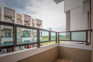 an empty balcony with a view of a building at Alan's House B&B in Jiaoxi