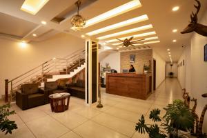 a lobby of a house with a staircase at Munnar Ice Queen Resorts in Munnar