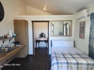 a bedroom with a bed and a sink and a desk at Sunrise Springs in Pahrump
