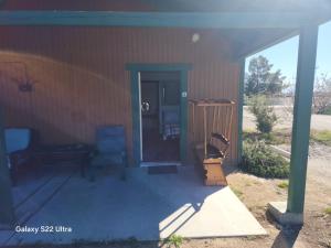 a front porch of a house with a blue door at Sunrise Springs in Pahrump