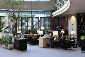 a lobby with chairs and tables in a building at JW Marriott Hotel Chongqing in Chongqing