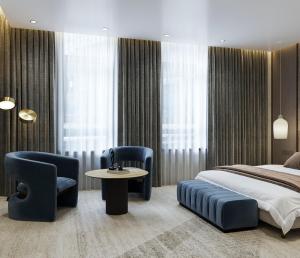 a bedroom with a bed and a table and chairs at Donatello Premium Almaty in Almaty