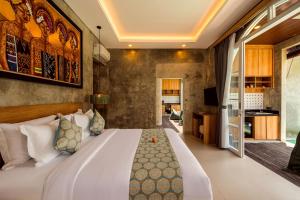 a bedroom with a large bed in a room at Subu Utamas Villas in Ubud +24 photos
