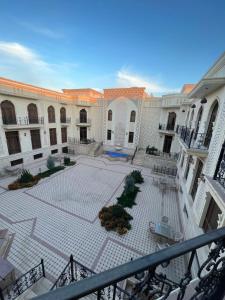 an empty courtyard in a large building with a staircase at Ark hotel PREMIUM in Bukhara