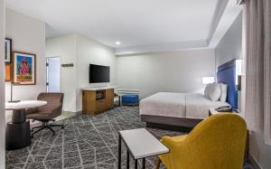 a hotel room with a bed and a tv at Hampton Inn Channel Islands Harbor in Oxnard