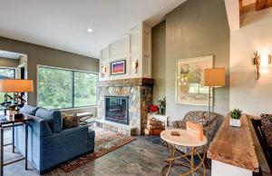 a living room with a couch and a fireplace at Garrison Hotel & Suites Dover-Portsmouth, an Ascend Collection Hotel in Dover