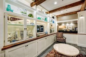 a kitchen with a counter with a table and a chair at Garrison Hotel & Suites Dover-Portsmouth, an Ascend Collection Hotel in Dover