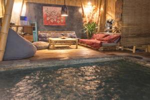 a living room with a large pool of water at Greengo Private POOL VILLA in Gili Meno