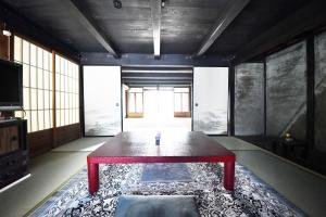 a room with a table in the middle of a room at minshuku studio enishi in Nagahama +14 photos