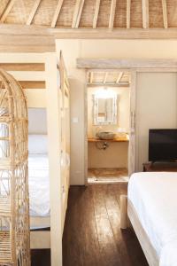 a room with two bunk beds and a bathroom at Greengo Private POOL VILLA in Gili Meno +7 photos