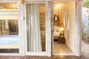 a room with a sliding glass door leading to a bedroom at Greengo Private POOL VILLA in Gili Meno