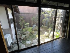 a view of a garden from the window of a house at minshuku studio enishi in Nagahama