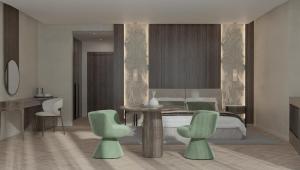 a bedroom with a bed and a table and chairs at Donatello Premium Almaty in Almaty