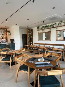 a dining room with wooden tables and chairs at Executive Studio at Bantree in Accra