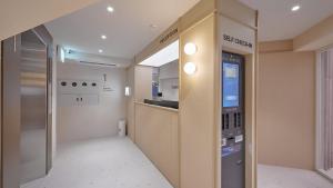 an empty room with a kitchen and a vending machine at Maison de Centum Busan in Busan