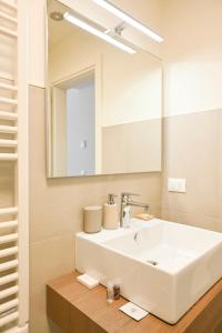 a bathroom with a white sink and a mirror at Residenza SubitoSanto - Appartamento 6A "Galileo" in Padova