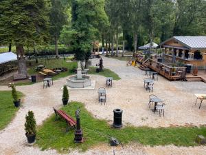 a park with tables and chairs and a fountain at EVASION LOUE #6 x2 people "La BRIQUERIE" in Lods +7 photos