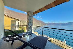 a balcony with a view of a lake and mountains at Residence degli Oleandri 6A in Argegno