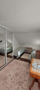 a living room with two beds and a table and a room with at Omakotitalo Pirintie 22, Härmä in Kauhava