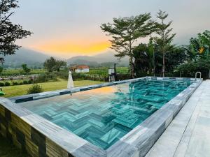 a swimming pool with blue tiles on top of it at LaLi Home in Hanoi