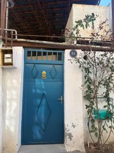 a blue door on the side of a building at Уютная комната in Ganja +18 photos