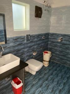 a bathroom with a white toilet and a sink at Hotel Grand Eagle Group in Jaipur