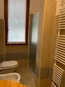 a bathroom with a toilet and a window at MONTECAMPI casa di charme in Meda +24 photos