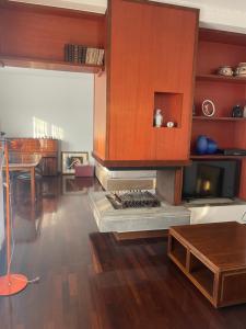 a living room with a fireplace and a table at MONTECAMPI casa di charme in Meda