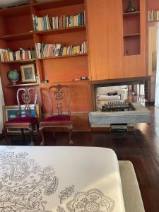 a living room with two chairs and a fireplace at MONTECAMPI casa di charme in Meda