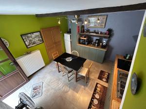 an overhead view of a kitchen with a table and green walls at Chez Germaine in Bouillon
