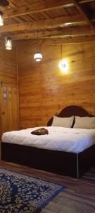 a bedroom with a bed in a wooden room at wood house vattakanal in Kodaikānāl