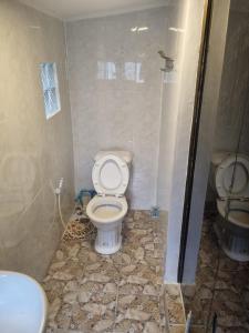 a bathroom with a toilet and a sink at Our Place Silk Island in Silk Island