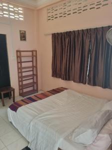 a bedroom with a large bed and a window at Our Place Silk Island in Silk Island