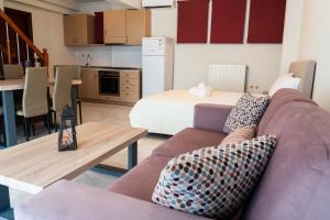 a living room with a couch and a kitchen at Anthemia Luxurious Villa in Iraklitsa